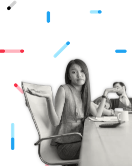 Woman in boardroom shrugging shoulders while colleague sleeps